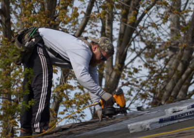 Erick Starr installing shingles on roof