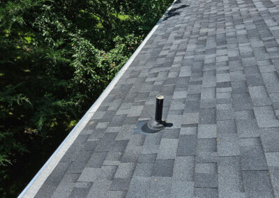 photo of new grey shingles and gutters with guards