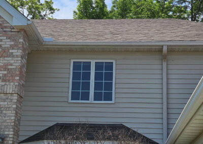 photo of home with new roofing, siding gutters, and windows