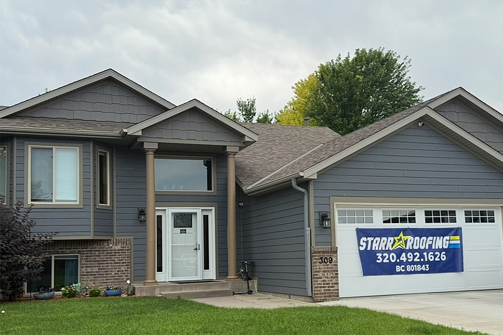 home with new roofing, siding, gutters, front door, and garage door
